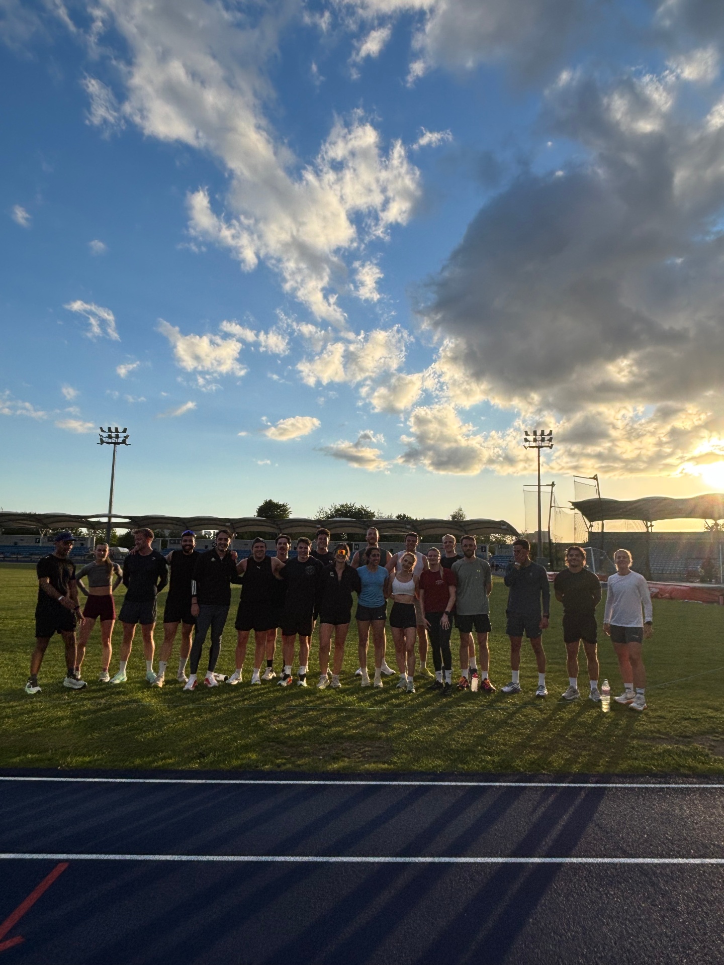 Community gathered on the track at sunset